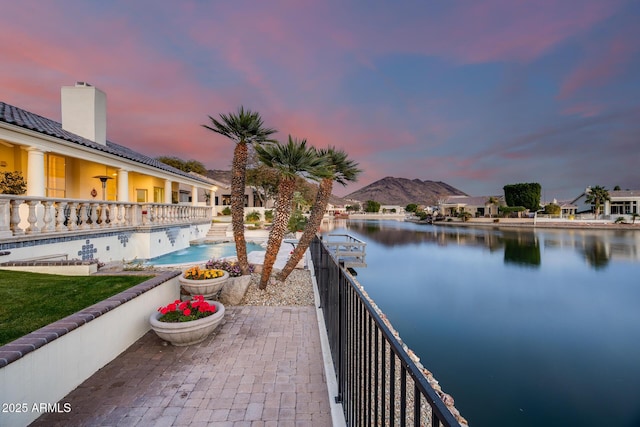 exterior space with a fenced in pool and a water view