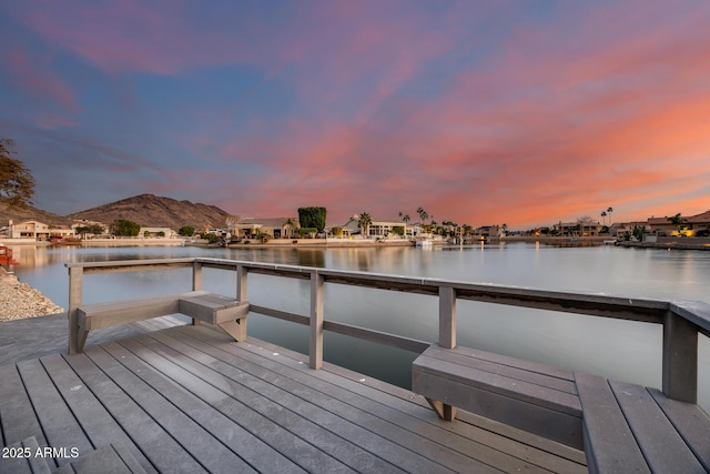 view of dock featuring a water and mountain view