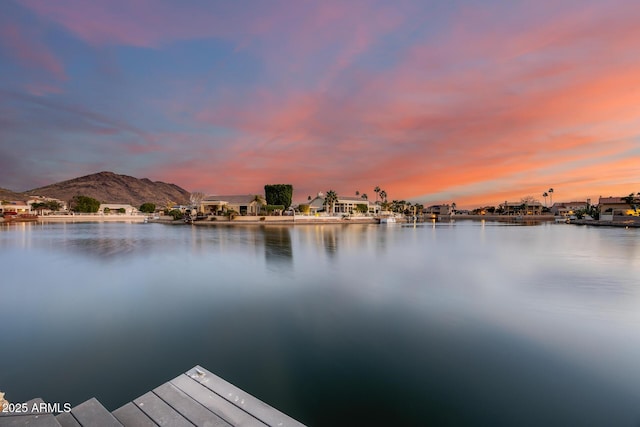 view of dock featuring a water and mountain view