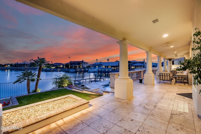 patio terrace at dusk with a water view