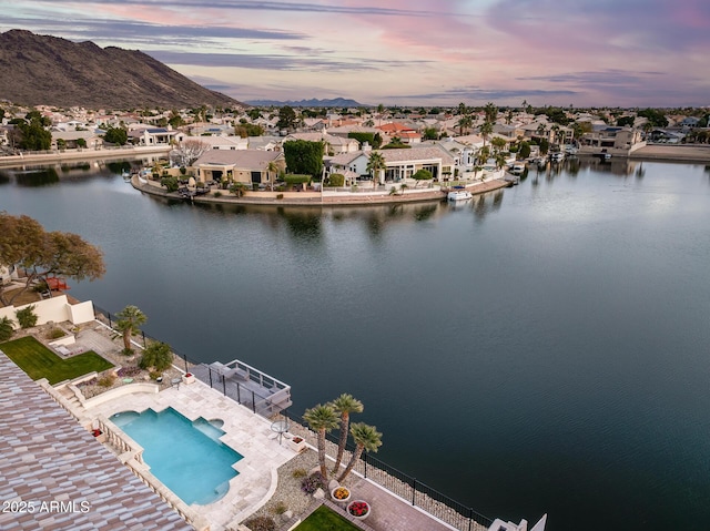 aerial view at dusk with a water and mountain view