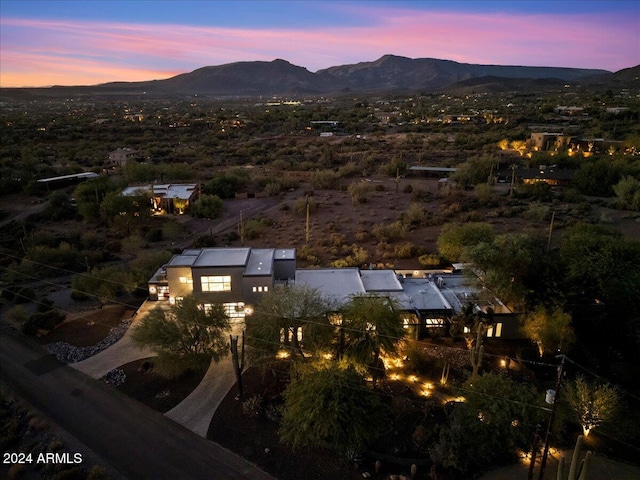 aerial view at dusk featuring a mountain view