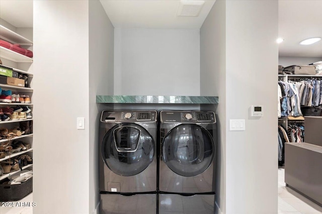 washroom with washer and dryer and light tile patterned flooring