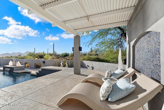 view of patio with pool water feature and a fenced in pool