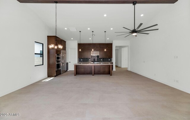 6727 N 9th Dr, Phoenix, AZ 85013 - kitchen featuring open floor plan, dark brown cabinetry, decorative backsplash, and recessed lighting