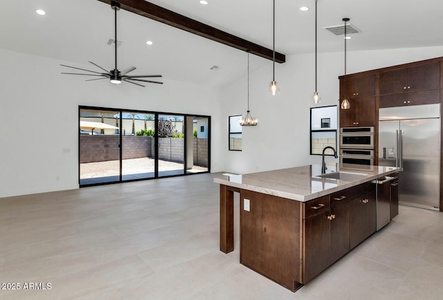 6727 N 9th Dr, Phoenix, AZ 85013 - kitchen with a sink, appliances with stainless steel finishes, open floor plan, ceiling fan, and dark brown cabinets