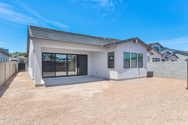 6727 N 9th Dr, Phoenix, AZ 85013 - back of property with stucco siding, a patio area, a fenced backyard, and a tile roof