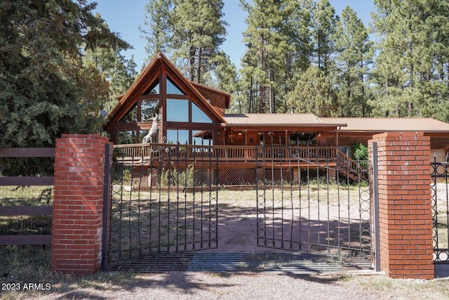 view of gate with a wooden deck