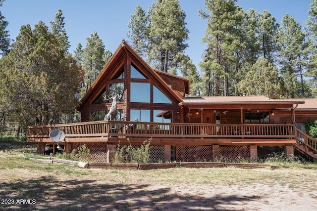 rear view of house featuring a wooden deck