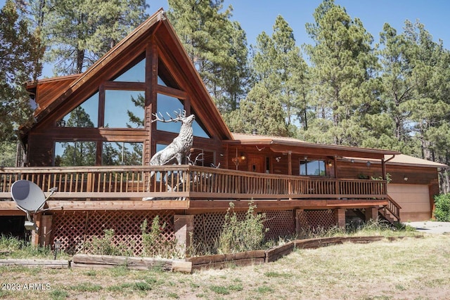 rear view of property featuring a wooden deck