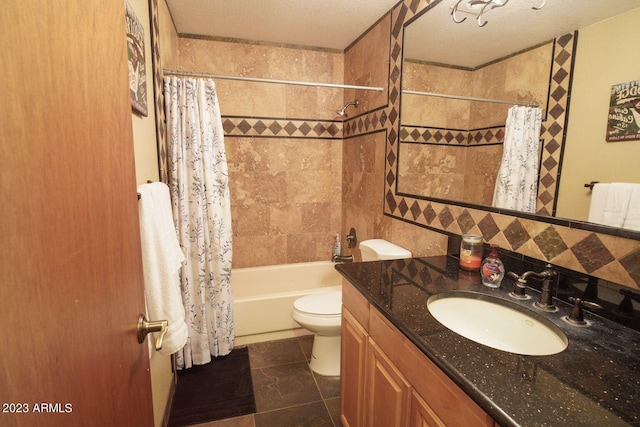 full bathroom with tile floors, vanity, shower / tub combo with curtain, toilet, and a textured ceiling