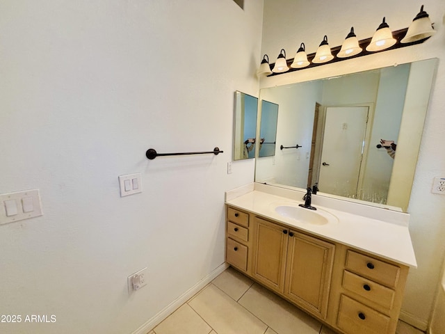 bathroom featuring tile patterned floors, baseboards, and vanity