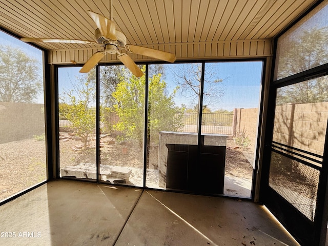 unfurnished sunroom featuring a wealth of natural light and wooden ceiling