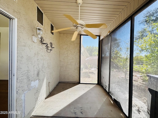 unfurnished sunroom with a ceiling fan