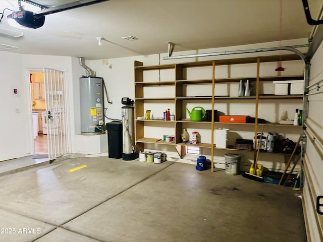 garage featuring gas water heater and a garage door opener