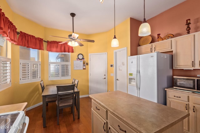 kitchen featuring stainless steel microwave, a center island, ceiling fan, dark wood finished floors, and white fridge with ice dispenser