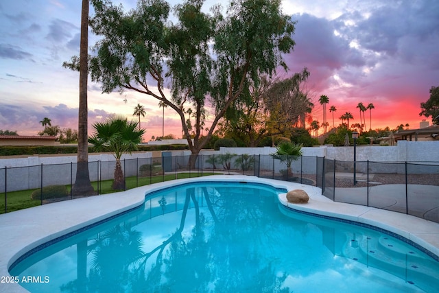 view of pool at dusk