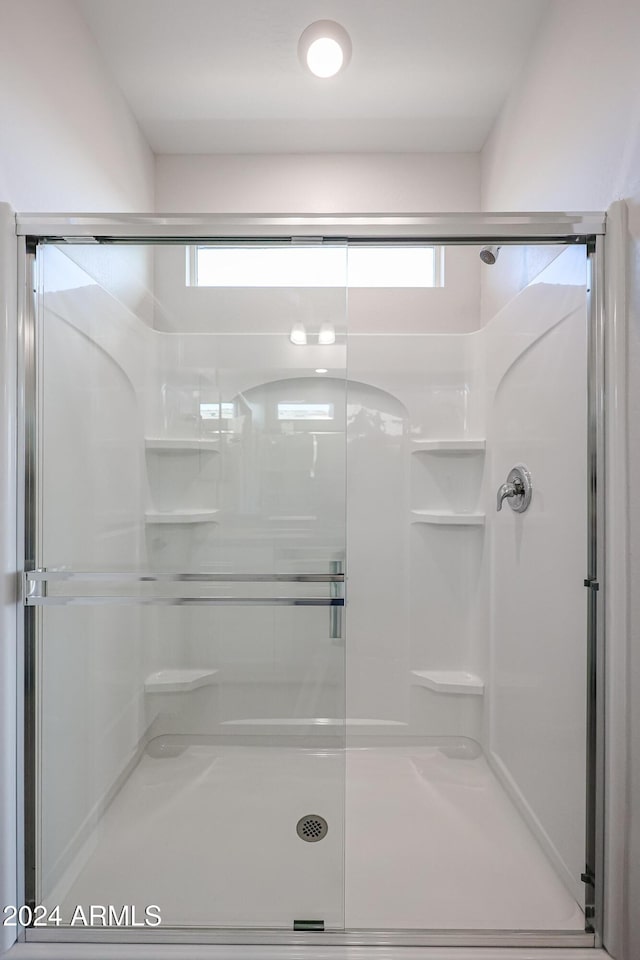 bathroom featuring plenty of natural light and an enclosed shower