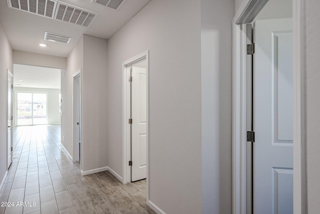 hallway with light hardwood / wood-style flooring