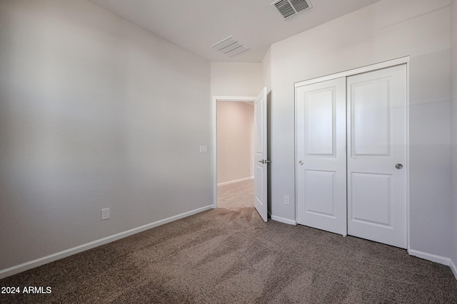 unfurnished bedroom featuring carpet floors and a closet