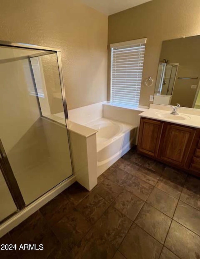 bathroom with vanity, plus walk in shower, and tile patterned flooring