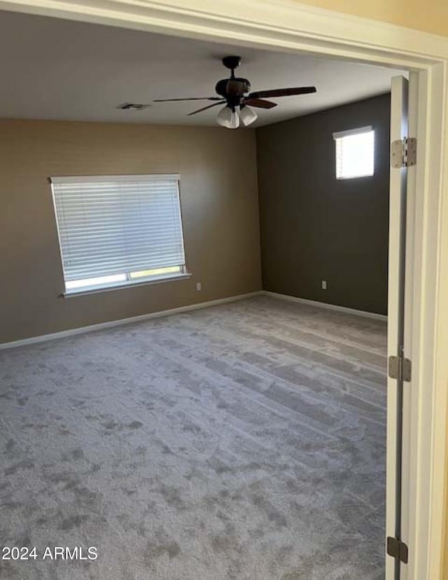 carpeted empty room with ceiling fan