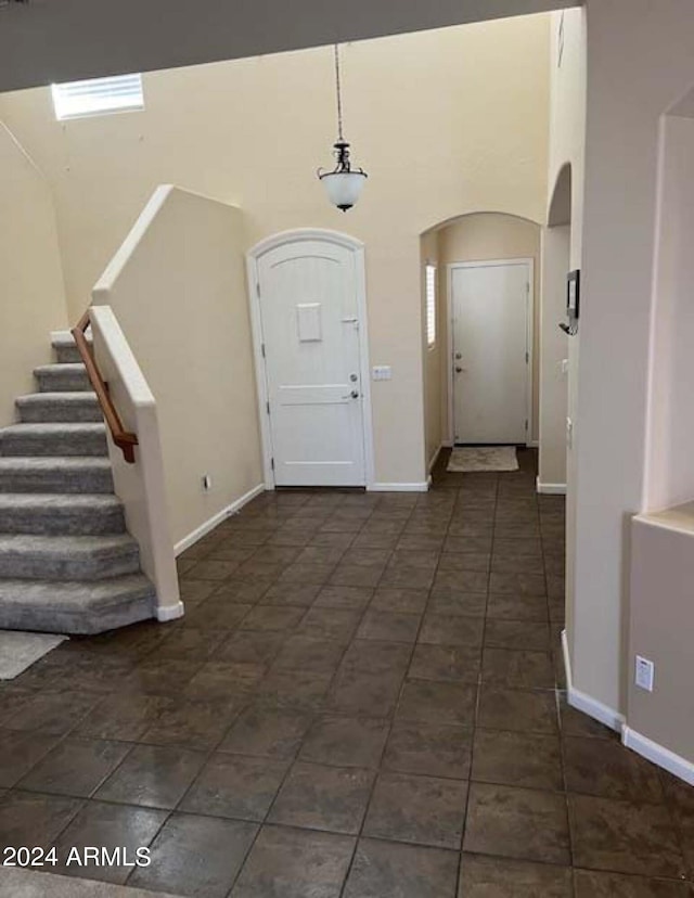 entrance foyer with dark tile patterned flooring