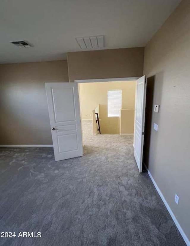 interior space featuring dark colored carpet