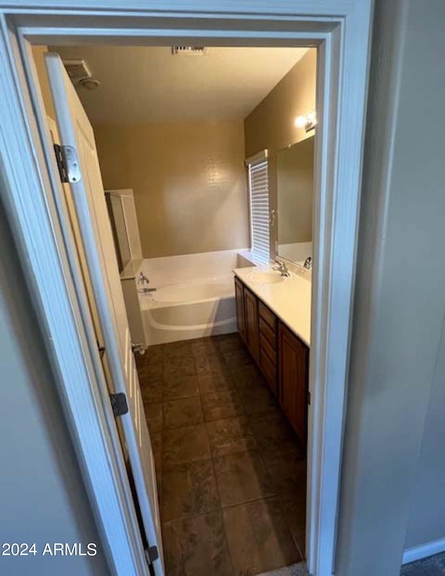 bathroom featuring a bath and vanity