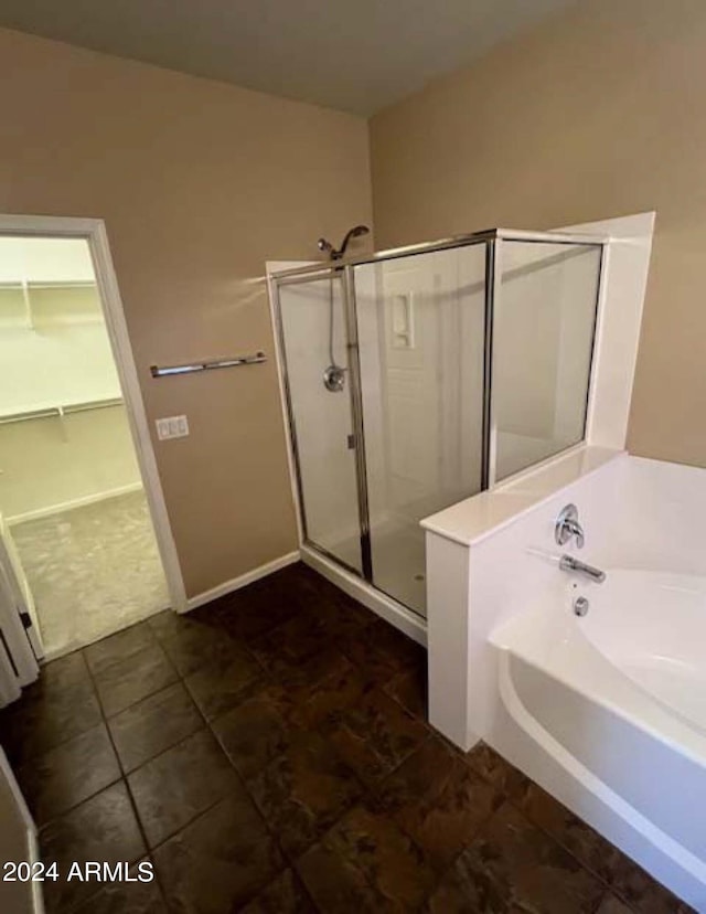 bathroom featuring tile patterned flooring and separate shower and tub