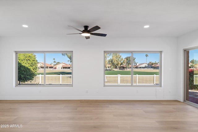 spare room featuring ceiling fan and light hardwood / wood-style flooring