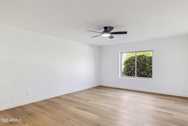 spare room with light hardwood / wood-style flooring and ceiling fan