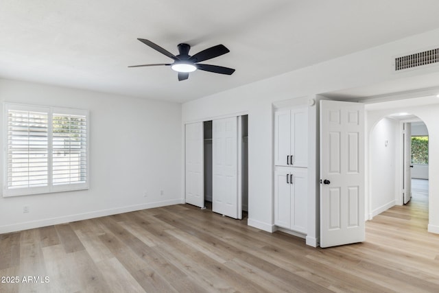 unfurnished bedroom with multiple windows, ceiling fan, and light hardwood / wood-style floors