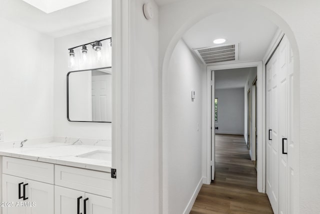 hall featuring sink and dark hardwood / wood-style floors