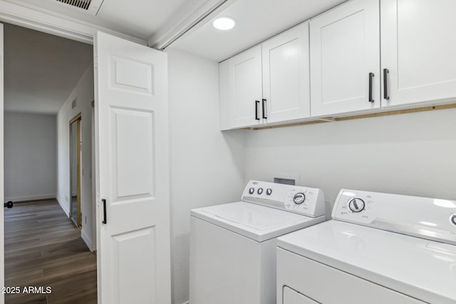 laundry area with cabinets, separate washer and dryer, and dark hardwood / wood-style floors