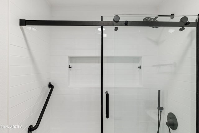 bathroom featuring a shower with shower door