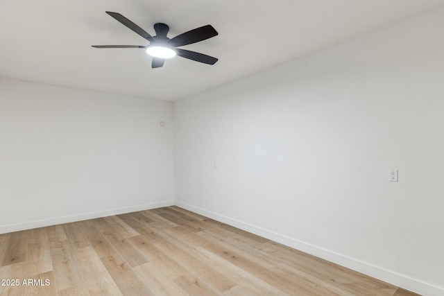 spare room with ceiling fan and light wood-type flooring