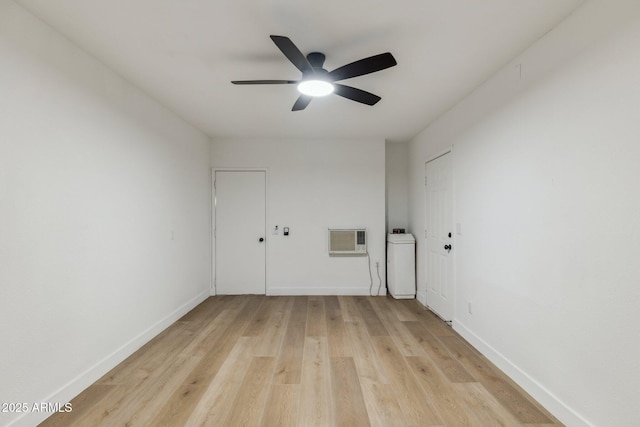 unfurnished room with a wall mounted air conditioner, light hardwood / wood-style floors, and ceiling fan