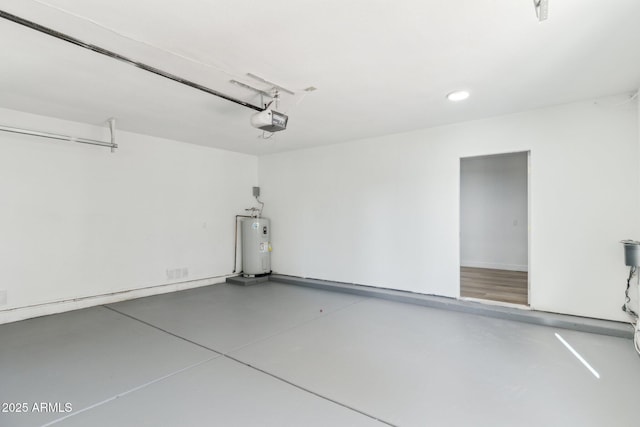 garage featuring electric water heater and a garage door opener