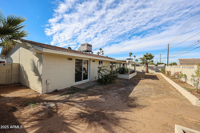 rear view of property featuring central AC