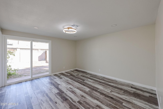 spare room featuring hardwood / wood-style floors