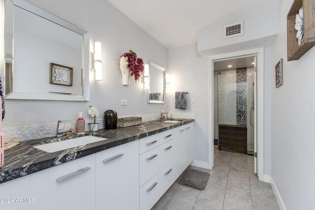 bathroom featuring vanity, tile patterned floors, and a shower with shower door