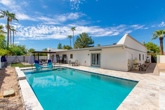 view of pool featuring a patio area and french doors