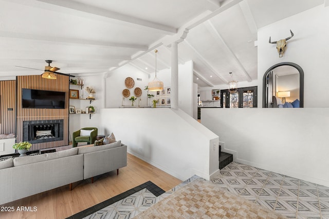 living room with ceiling fan and lofted ceiling with beams