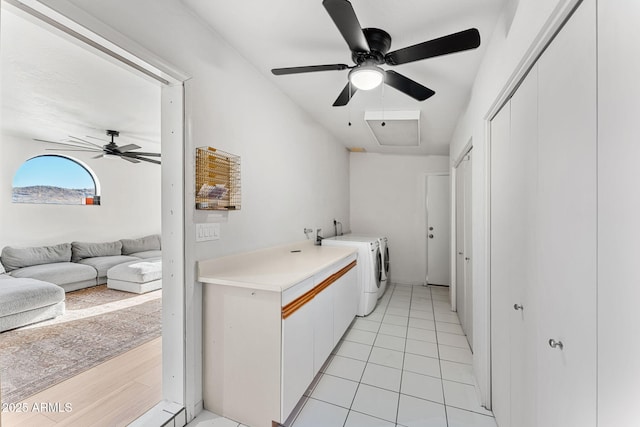 laundry room featuring ceiling fan, light tile patterned floors, and washer and dryer