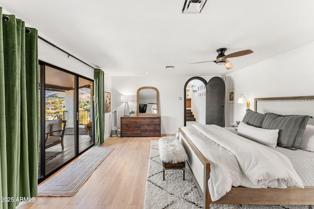 bedroom with ceiling fan, access to exterior, and light hardwood / wood-style floors