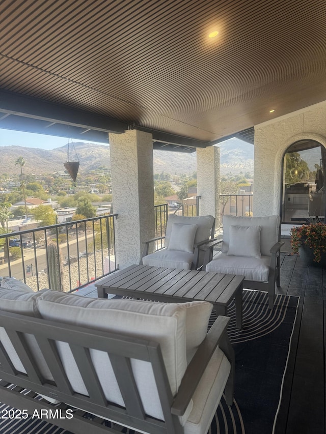 view of patio with a mountain view and a balcony