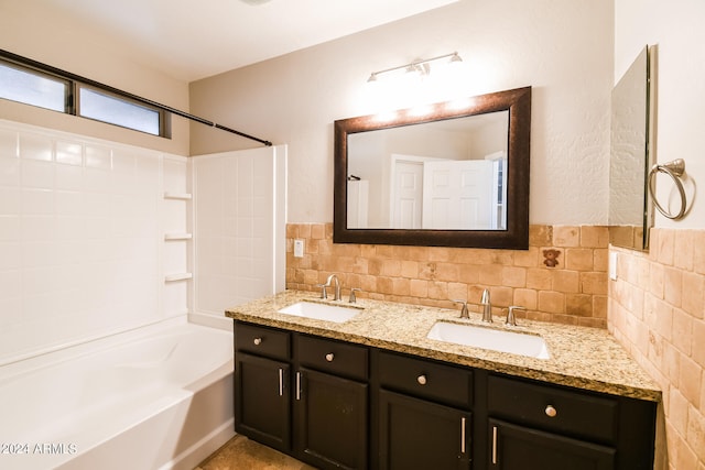 bathroom featuring vanity, shower / washtub combination, and backsplash