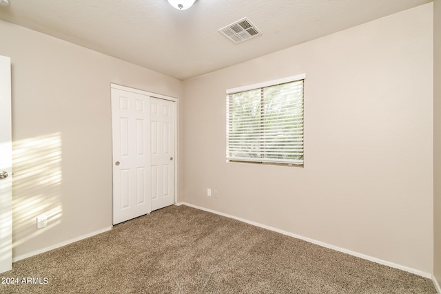 unfurnished bedroom featuring a closet and carpet floors