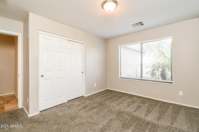 unfurnished bedroom featuring a closet and carpet